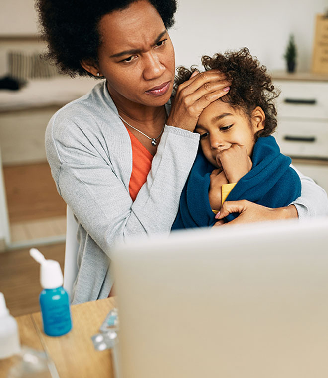 Caring black mother holding her sick child