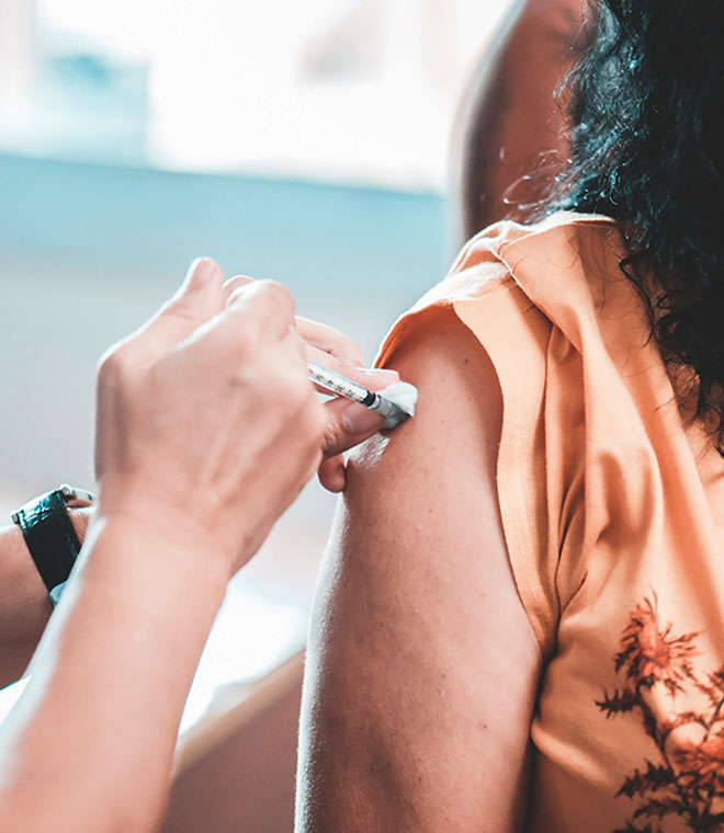 Woman receiving shot in her arm