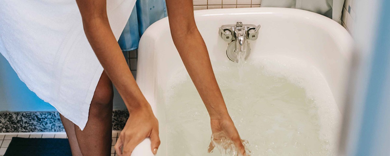 Black woman running a bath